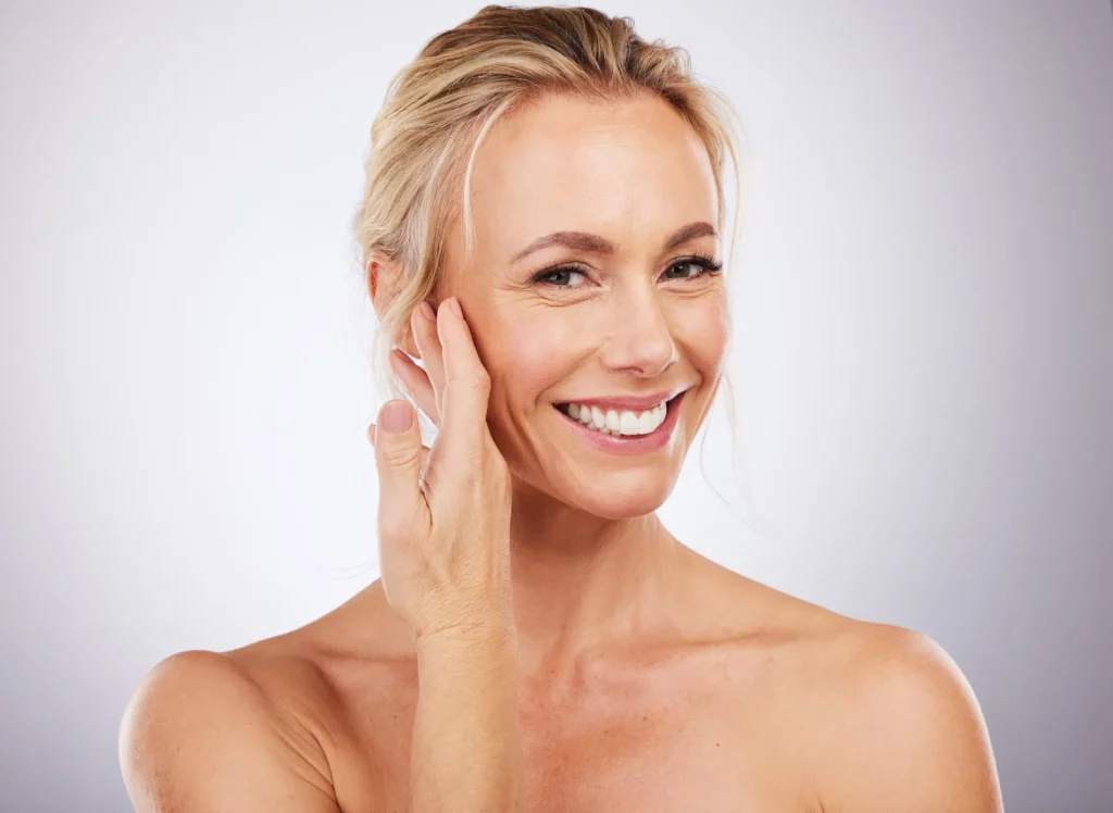 MIddle Aged woman smiling after getting Rosacea treatment in San Mateo