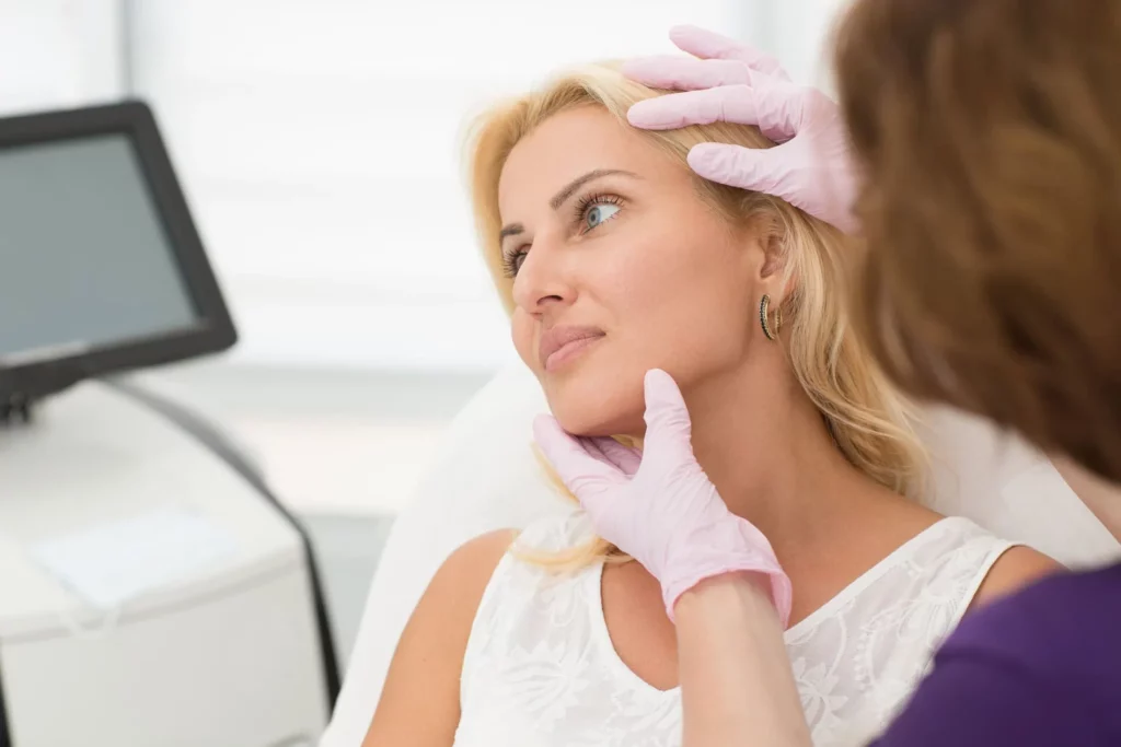 Aesthetician examining girl for sculptra treatment in San Mateo, CA