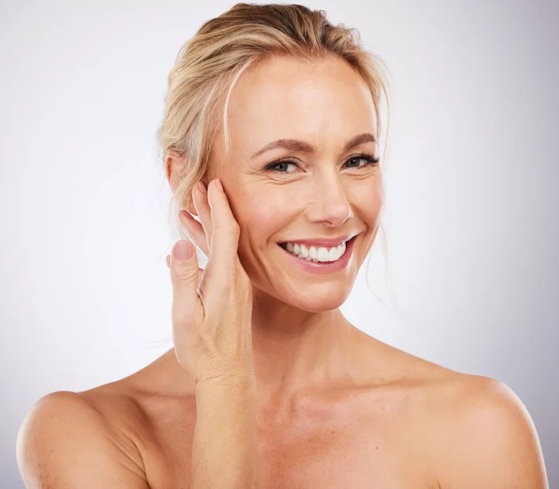 MIddle Aged woman smiling after getting Rosacea treatment in San Mateo